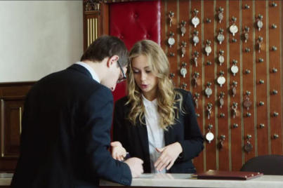A photo of a gentleman in a business suit checking in to his hotel